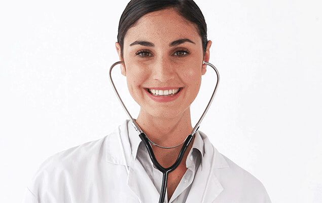 A clinician smiling in a white coat with a stethoscope